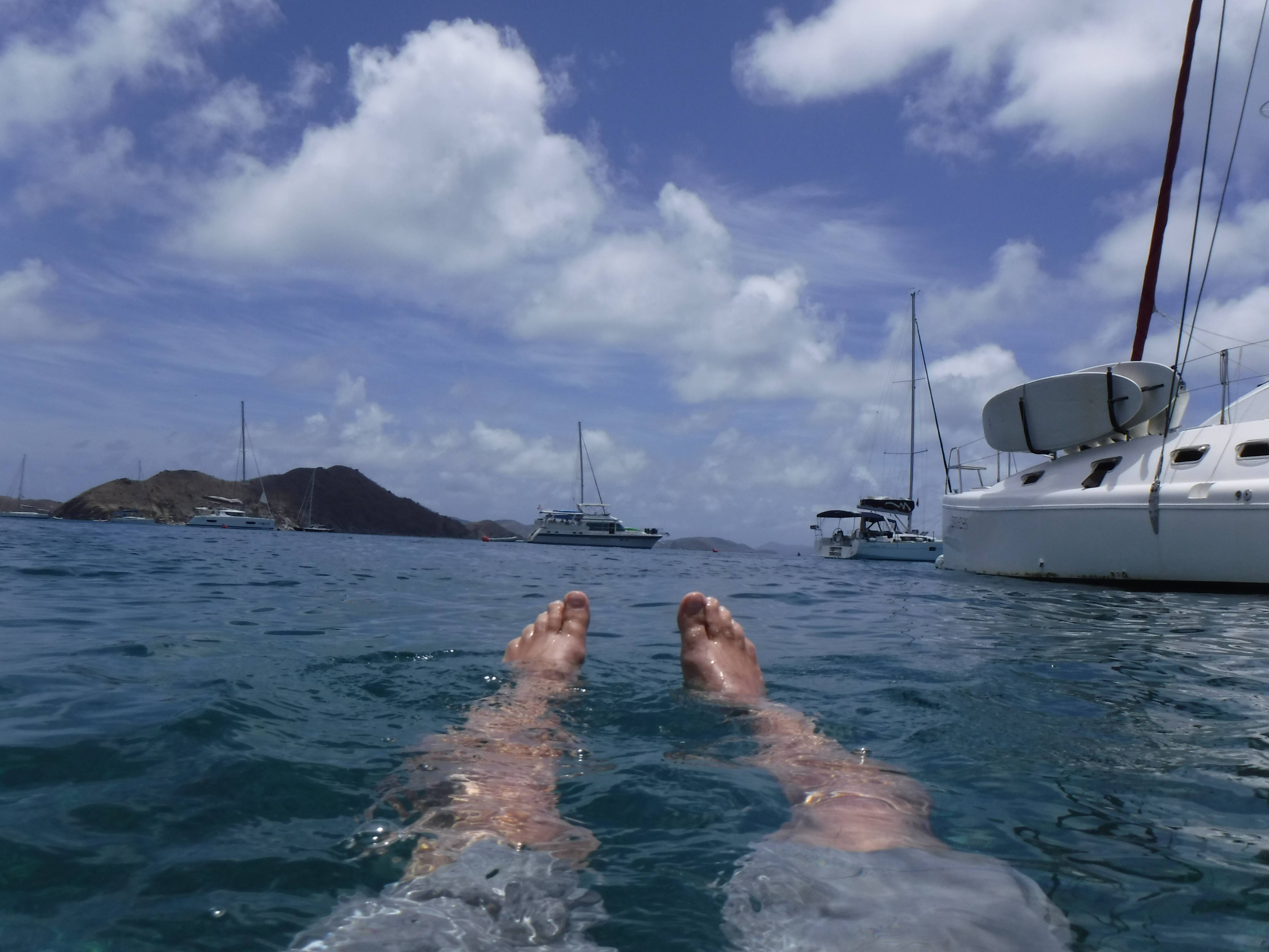 POV of person in water and a Catamaran